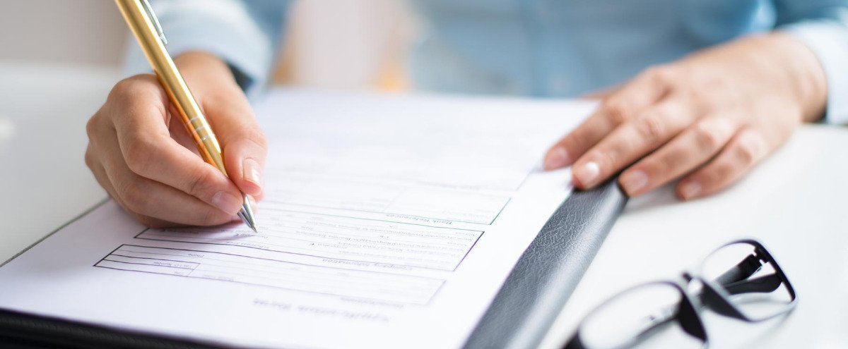 Gentlemen writing on a form