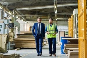 2 gentlemen walking through a workplace