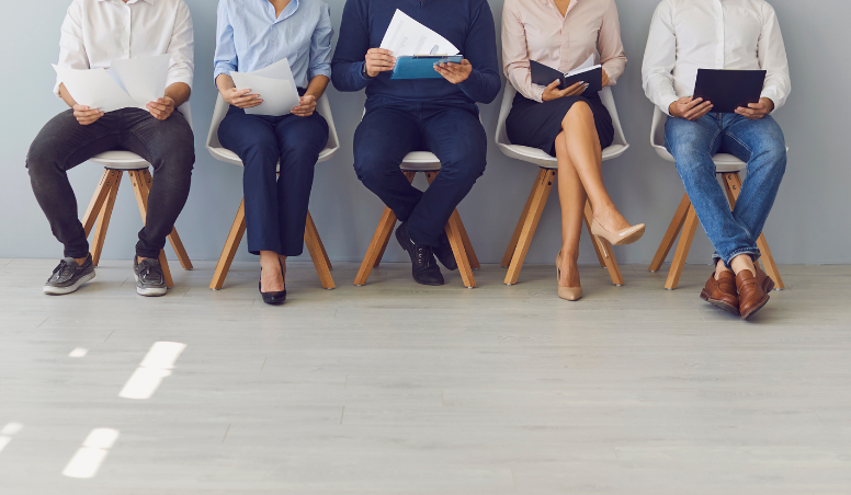 People sitting in chairs waiting for an interview