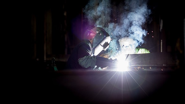 People welding metal